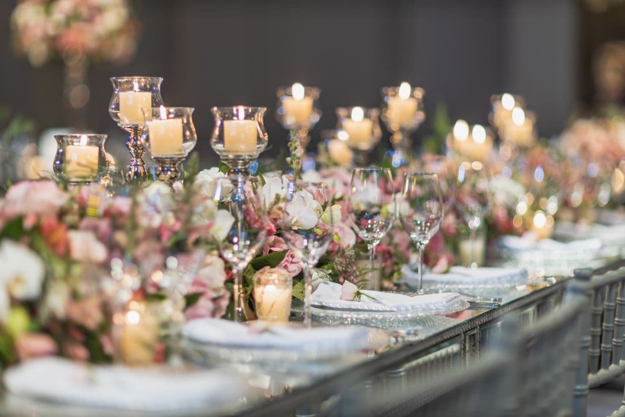Elegantly arranged event tables with floral centrepieces